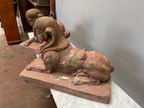 Seitenansicht einer liegenden antiken Sphinx auf rechteckigem Sockel. Die Aufnahme zeigt die harmonischen Proportionen des Löwenkörpers, den weiblichen Kopf sowie die historische Oberfläche mit schöner Alters- und Farbpatina.
