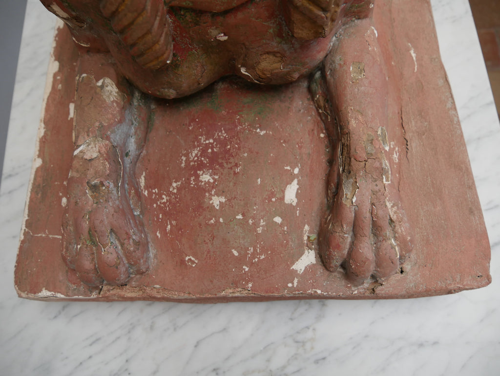 Detailaufnahme der Vorderpfote und des Sockels einer antiken Sphinx. Sichtbar sind die plastische Modellierung des Löwenkörpers sowie die gealterte Farbfassung mit kleinen Abplatzungen.