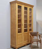 Originaler Lehrmittelschrank aus Weichholz von etwa 1910 in restauriertem Zustand. Die große zweitürige Vitrine mit verglasten Türen, verstellbaren Einlegeböden und schöner Kranzleiste zeigt die komplette Frontansicht des historischen Schranks.