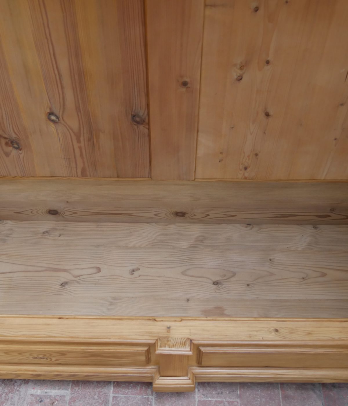 Detailaufnahme des unteren Innenbereichs mit massiver Holzverbindung und sorgfältig gearbeiteten Profilen. Die hochwertige Verarbeitung verdeutlicht die stabile Konstruktion des Gründerzeit-Kleiderschranks.