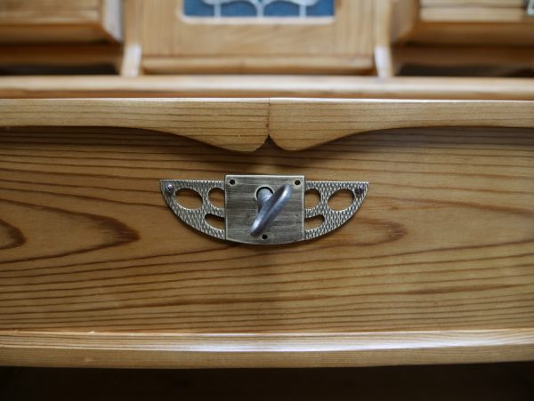 Nahaufnahme eines originalen Jugendstil-Schubkastenbeschlags. Der kunstvoll gestaltete Beschlag ist vollständig erhalten und gehört zur originalen Ausstattung des Vertikos.