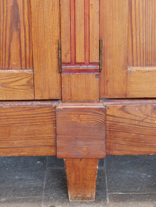 Detailaufnahme des massiven Sockelbereichs des Jugendstil-Bibliotheksschranks. Die stabile Konstruktion und die originale Holzoberfläche verleihen dem Möbel einen sicheren Stand und eine hochwertige Optik.