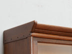 Schräg aufgenommene Detailansicht des oberen Seitenbereichs des modularen Jugendstil-Bücherschranks. Das Bild zeigt den sauberen Übergang zwischen Oberteil und Seitenwand sowie die originale Eichenholzoberfläche.