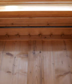 Detail der oberen Zierleiste und des Aufsatzes aus Weichholz am Jugendstil-Kleiderschrank.
