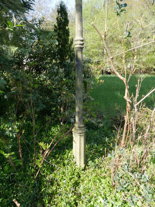 Gesamtansicht einer historischen Gartenlaterne mit vollständigem Mast und elegantem konischem Aufbau in ursprünglicher Umgebung.