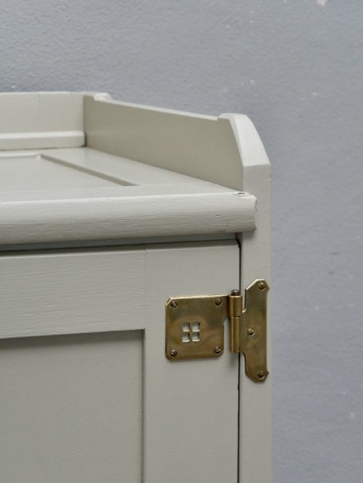 Detailaufnahme der oberen rechten Schrankecke mit originalem Messingbeschlag, sauber gearbeiteten Profilen und der hochwertigen hellen Neufassung des dreitürigen Kleider- und Wäscheschranks von Richard Riemerschmid.