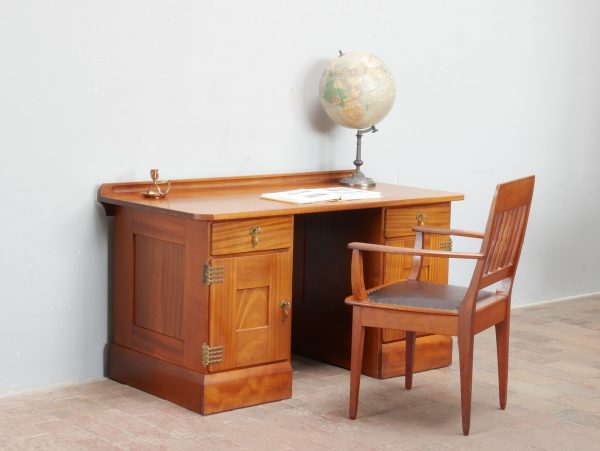 Gesamtansicht des originalen Jugendstil-Schreibtisches von Richard Riemerschmid, gefertigt 1906 in den Deutschen Werkstätten Dresden-Hellerau aus massivem Mahagoni. Der freistehende Schreibtisch mit originalen Messingbeschlägen, schöner Patina und klaren Werkbund-Formen befindet sich in außergewöhnlich gutem Originalzustand.