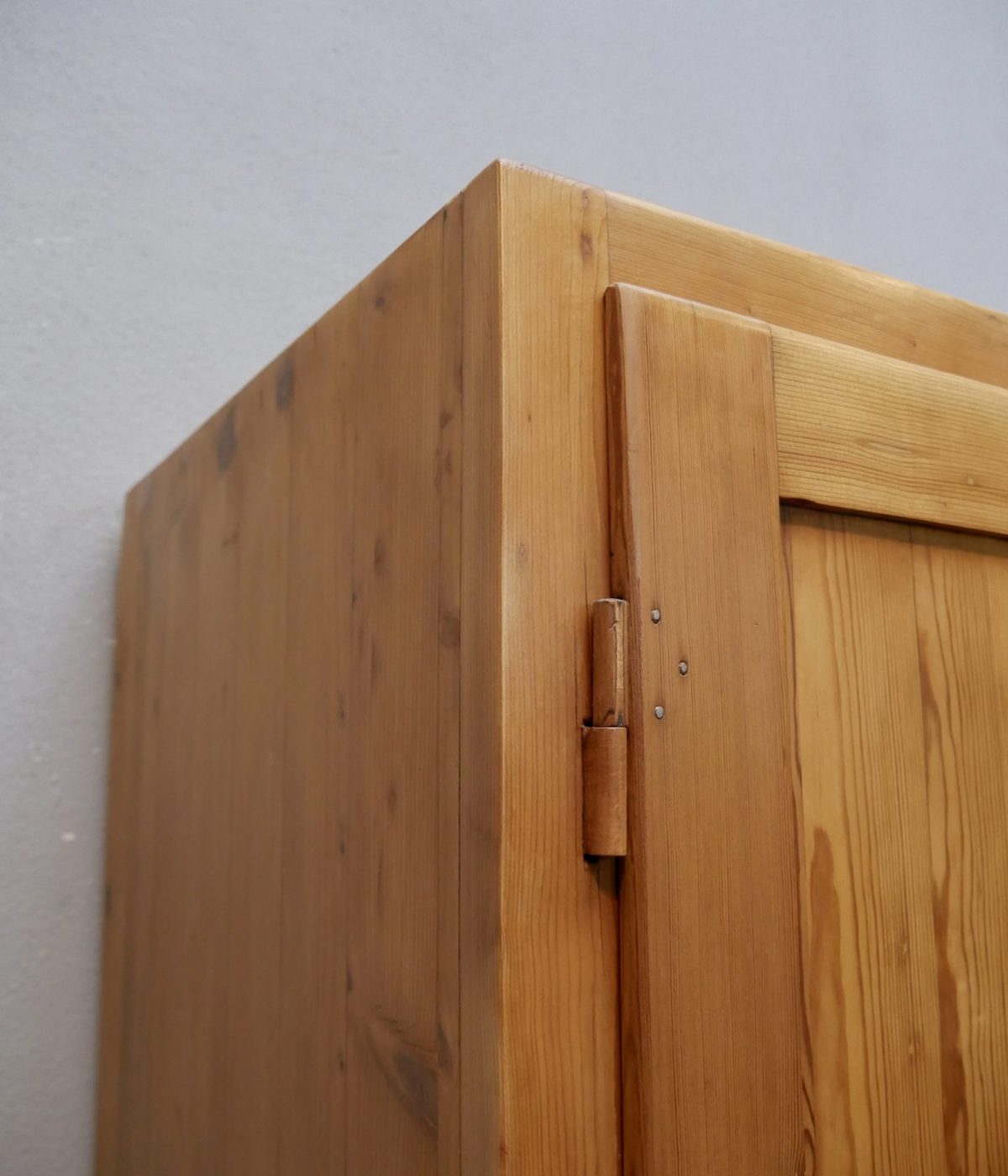 Detail der oberen Ecke des restaurierten Weichholz-Spinds mit sauber restaurierter Holzoberfläche und originaler Konstruktion.