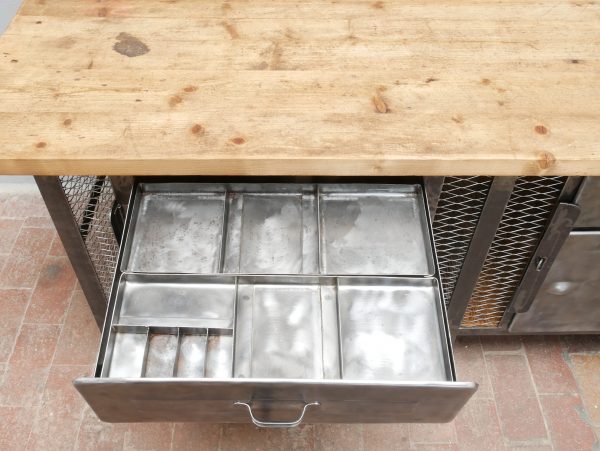 Detailaufnahme der geöffneten Metallschublade mit Einsatz mit restaurierter Innenausstattung und originaler Metallfront im historischen Industriedesign.
